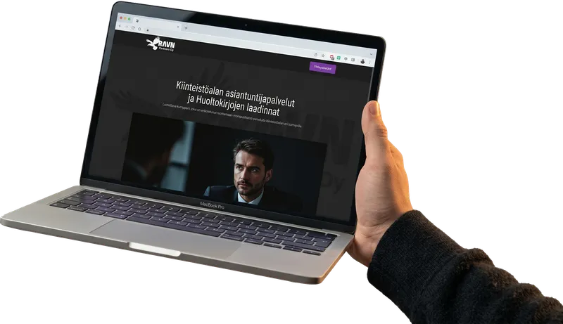 Laptop held in a hand, showing a website